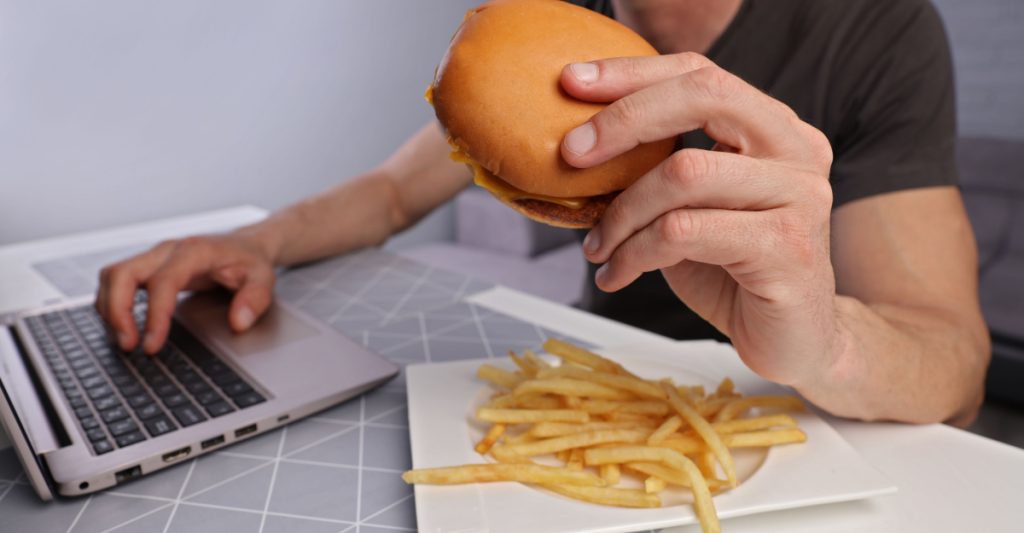 A Man Eating Fatty Foods