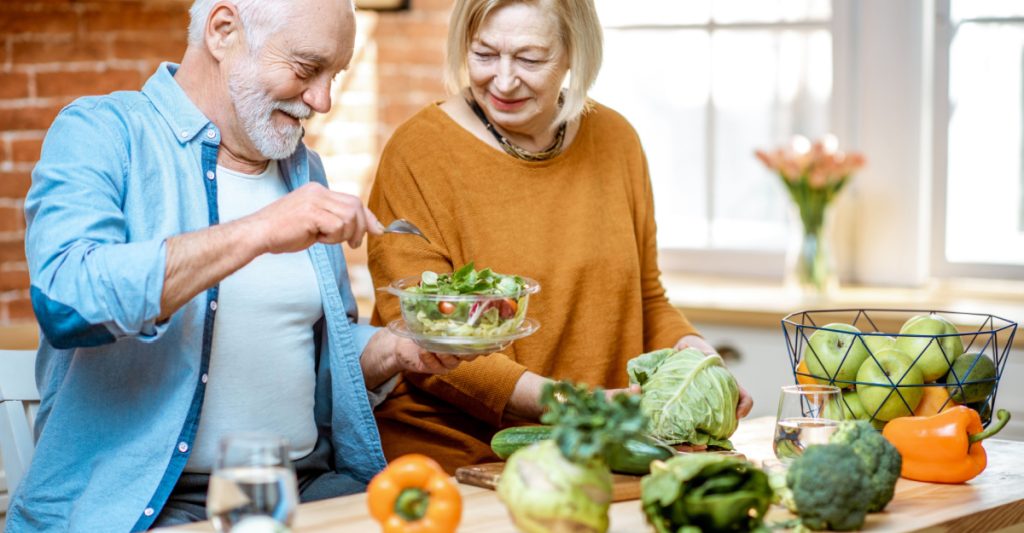 A senior couple preparing a healthy meal