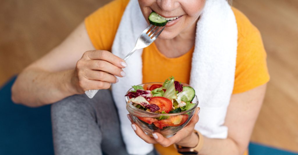 A Healthy Woman Eating Salad