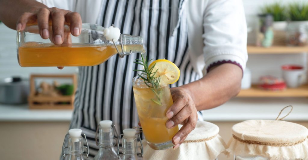 Close Up of a Man Pouring Kombucha