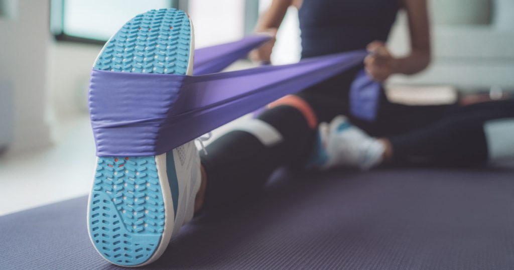 A close up of a woman doing resistance training