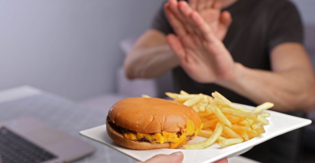 A Man Refusing To Eat Harmful Food