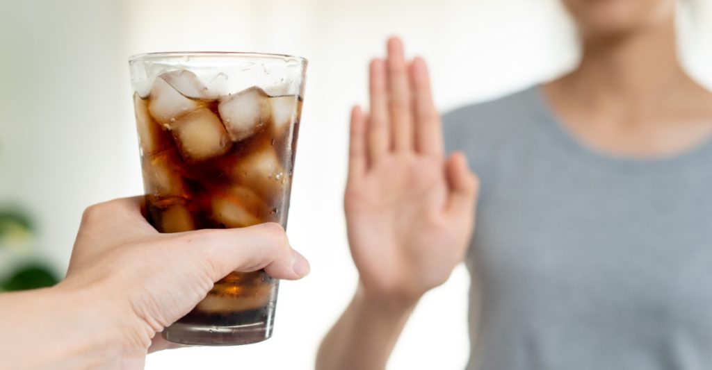 A Woman Refusing a Sugary Drink