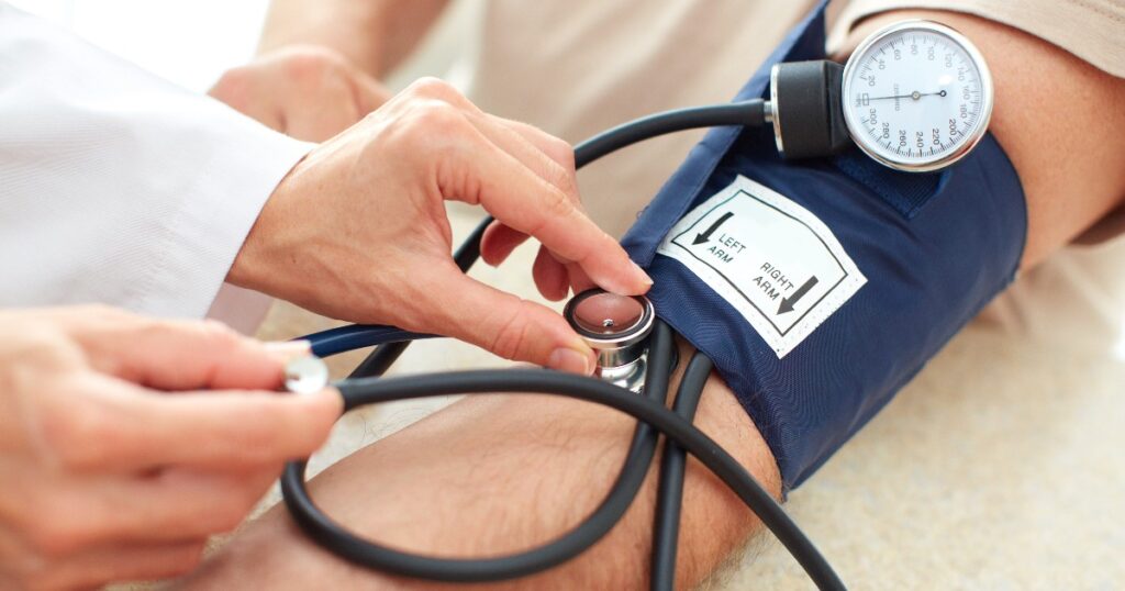 Blood pressure cuff being wrapped around an arm for measurement