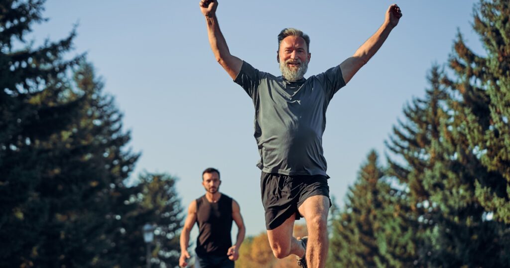 A close up of an older man winning a race