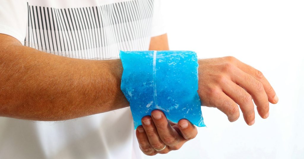 Man holding a cold compress on his wrist