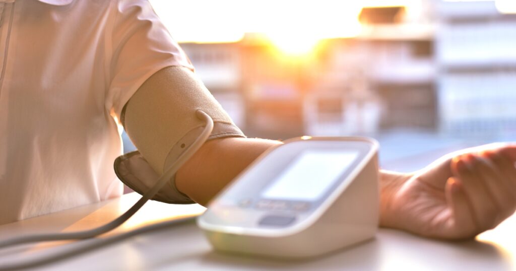 Close up of a person measuring their blood pressure in the morning